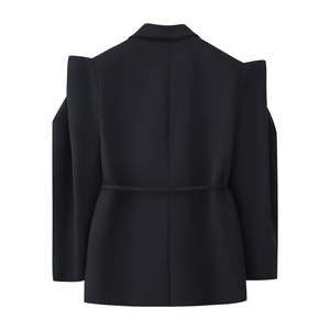 Detail of architectural shoulder pads and belted waist on black blazer jacket