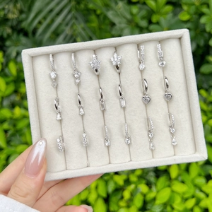 Detailed set of S925 silver earrings with zircon heart and star pendants in a jewelry box