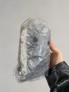 Bulk package of gray knitted crocodile socks showing detailed knit texture in a box