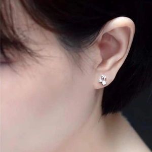 Chic cherry stud earrings with cubic zirconia stones worn on a female ear