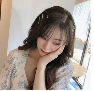 Detailed view of five sparkling rhinestone hair clips worn on wavy hair for elegant styling