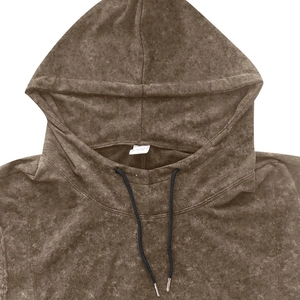 Detail of vintage brown hoodie neckline with metal tip drawstrings and washed texture
