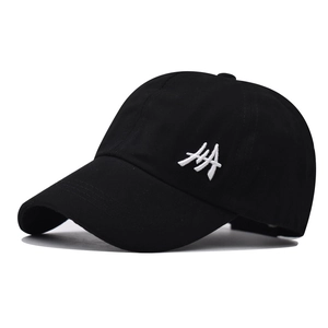 Detail of black cotton ponytail baseball cap featuring white side embroidery and curved brim