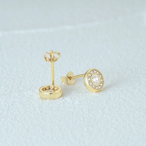 Close-up of gold 925 silver C-shape stud earrings with pavé set sparkling crystals
