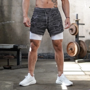 Detail of men's double-layer athletic shorts featuring dark camo and white inner lining