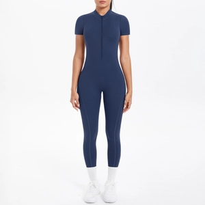 Front view of tight navy blue short sleeve jumpsuit with half-zipper and high collar detail