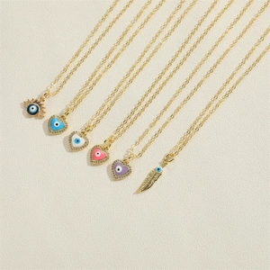 Golden Evil Eye necklaces set with heart, sun and feather pendants featuring colorful enamel