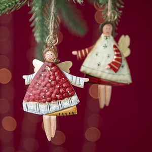 Vintage metal angel Christmas tree ornaments in red and white on pine branches