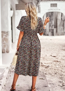 Detail of floral V-neck midi dress featuring ruffled short sleeves and a cinched waist design