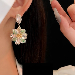 Elegant gold flower earrings with green crystals and sparkling diamond studs for women