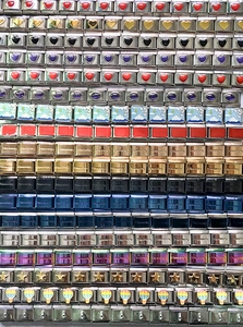 Detailed view of various Italian charms with colorful enamel designs on stainless steel base