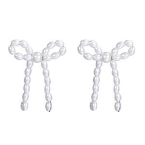 Close-up of pearl bow earrings featuring delicate white pearls in a graceful bow design
