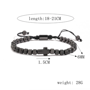 Detail view of adjustable black beaded bracelet with cross pendant and size dimensions