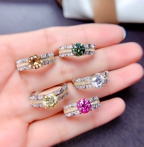 Collection of five colorful round cut faux moissanite rings with gold layered bands