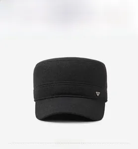 Front view of black cadet cap featuring a metallic triangle plaque and wool-like texture