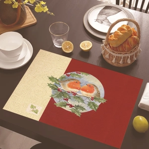 Close-up of a festive rectangle placemat with robin and holly print on wooden table