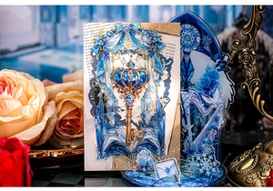 Detailed close-up of blue fantasy crown key PET sticker with vintage rose and lantern decor