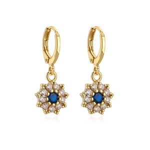 Close-up of gold-plated flower earrings with dark blue center stone and zircon petals