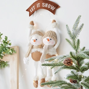 Pair of plush Christmas snowman hangers with Let It Snow sign for festive door and wall decor