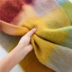 Close-up of thick rainbow plaid scarf showing the soft mohair texture and fluffy fabric