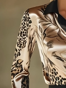 Detail of satin floral leopard print blouse showing champagne gold silk-like texture