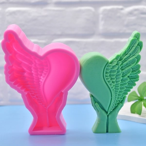 Silicone mold for winged heart held by hands for DIY candles and soap making