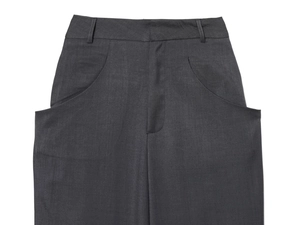 Detail view of high-waisted dark grey wool trousers showing waistline and side pockets