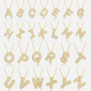 Macro display of full set A-Z gold bubble letter pendants with sparkling pavé crystals