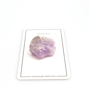 Macro shot of natural raw amethyst stone attached to a handmade gift card