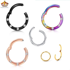 Detail of 316L stainless steel seamless clicker rings set with five crystals in five colors