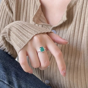 Minimalist 925 sterling silver ring with emerald green rectangular gemstone on hand