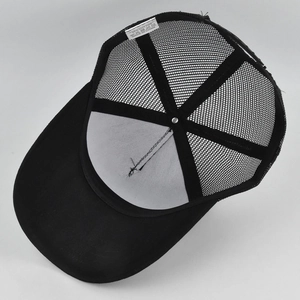 Detailed interior of black mesh truckercap showing 65% cotton label and stitching