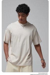 Detail of cream white oversized cotton t-shirt with drop shoulder design and retro text