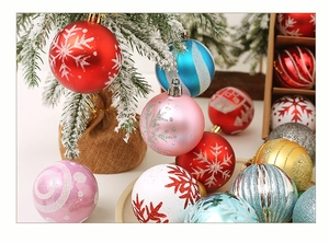 Close-up of assorted matte and glitter Christmas balls hanging on a snowy tree branch