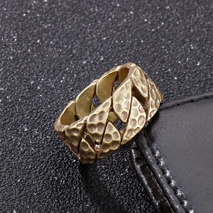Macro shot of retro wide chain link ring with vintage gold hammered texture detail
