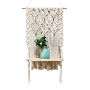 Handwoven cotton macrame wall hanging shelf with wooden rack for home decor storage