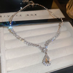 Close-up of sparkling rhinestone waterdrop pendant necklace in a velvet jewelry box