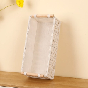 Handwoven rectangular cotton rope storage basket with wood handles and linen lining