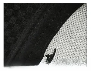 Detailed close-up of wide black sweatband and premium plaid fabric stitching on the cap