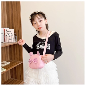 Pink girl's crossbody bag with sequin bow and cute cat ears on a child model