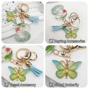 Floral resin letter S keychain with green butterfly and light blue tassel charm