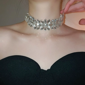 Close-up of a silver choker necklace with teardrop crystals on a model neck