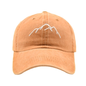 Detail shot of white mountain embroidery on washed cotton vintage baseball cap