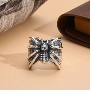 Detailed close-up of a punk-style spider on web relief on an adjustable silver ring