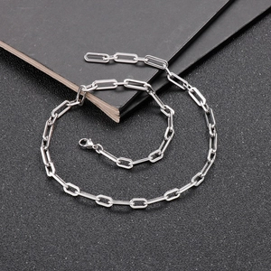 Silver stainless steel paperclip link chain necklace with lobster clasp on black background