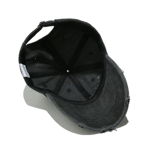 Detail view of cotton baseball cap interior featuring reinforced seams and distressing