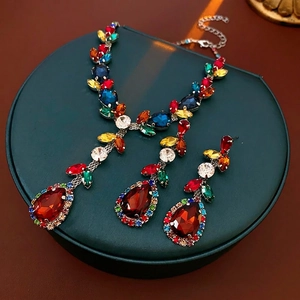 Vintage jewelry set with teardrop crystals and silver needles in a luxury display