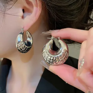 Minimalist silver geometric hoop earrings with textured quilted patterns for women