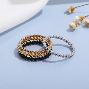 Detailed view of twisted rope minimalist rings in rose gold, gold, black, and silver steel