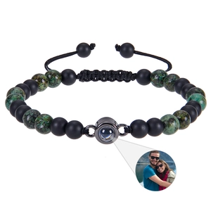 Detail view of custom projection bracelet with matte black beads and couple photo